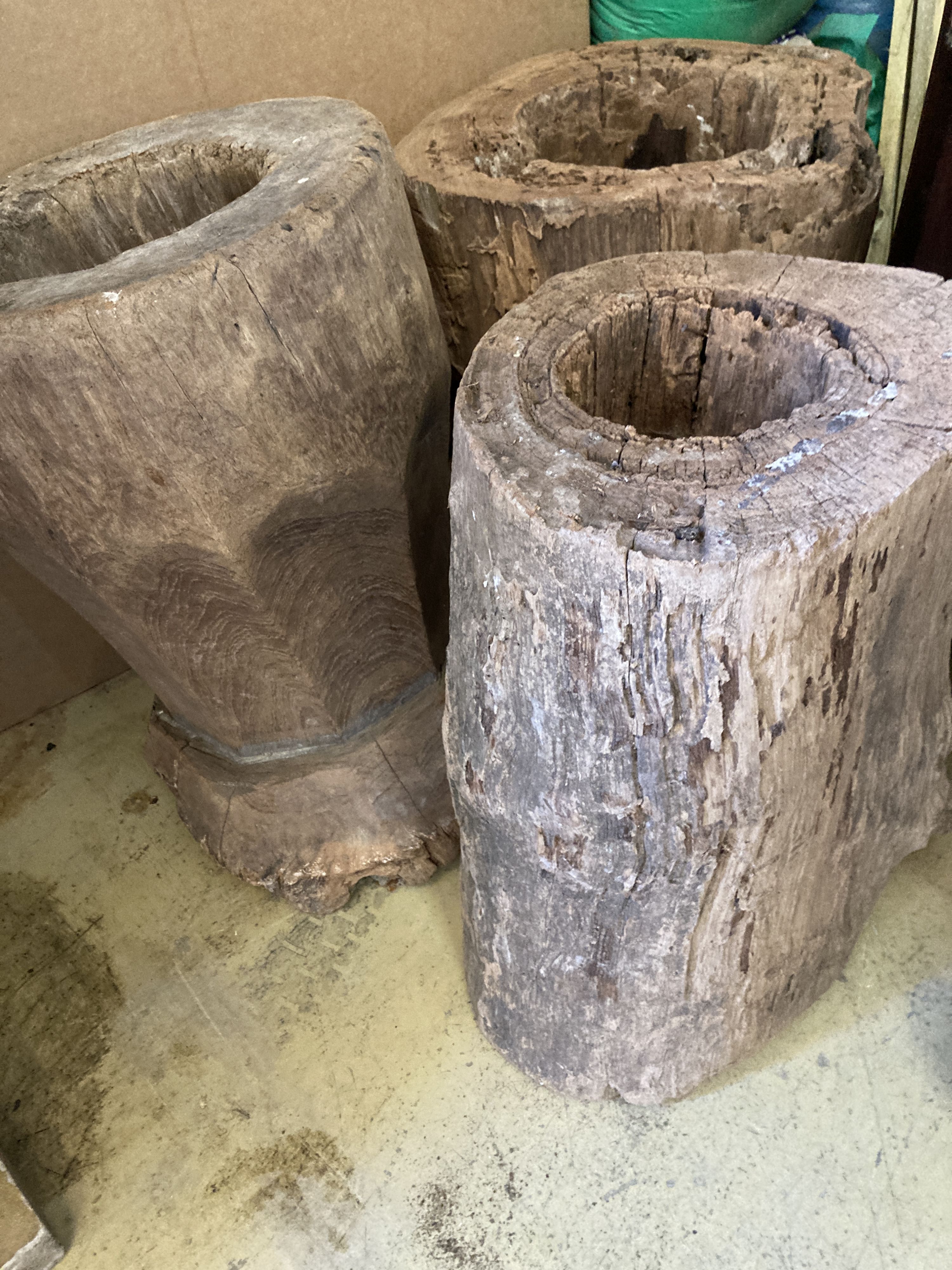 Three Indonesian hardwood rice mortars, largest 52cm high